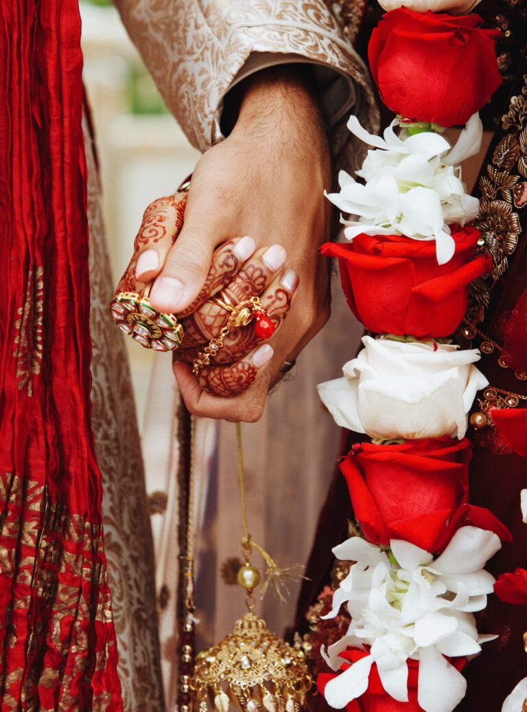 Authentic indian bride and groom's hands holding together in tra